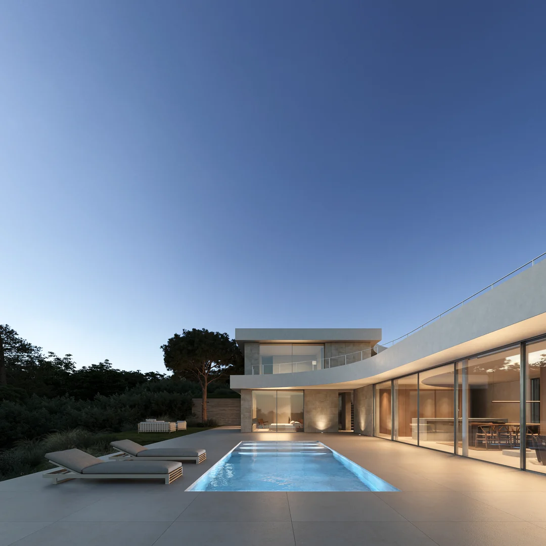 La casa al atardecer desde la piscina iluminada